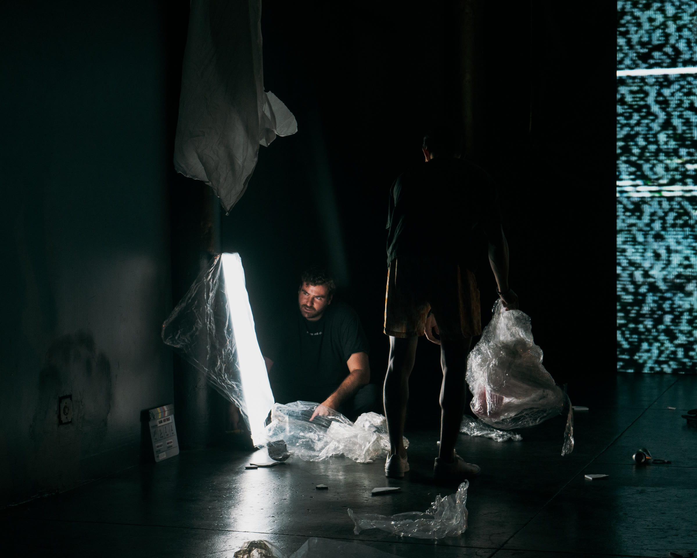 Adam Linssen shaping light on a dark studio set