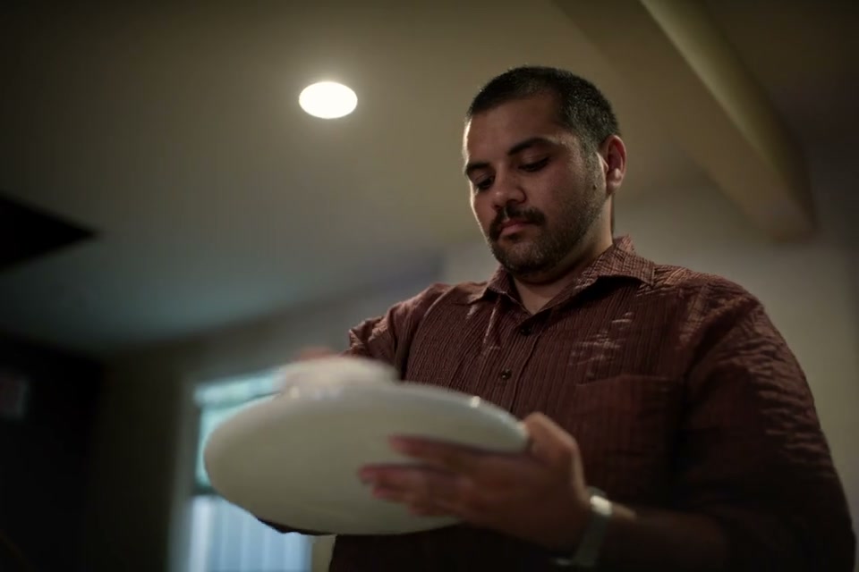 A chef slicing truffles over a plated course