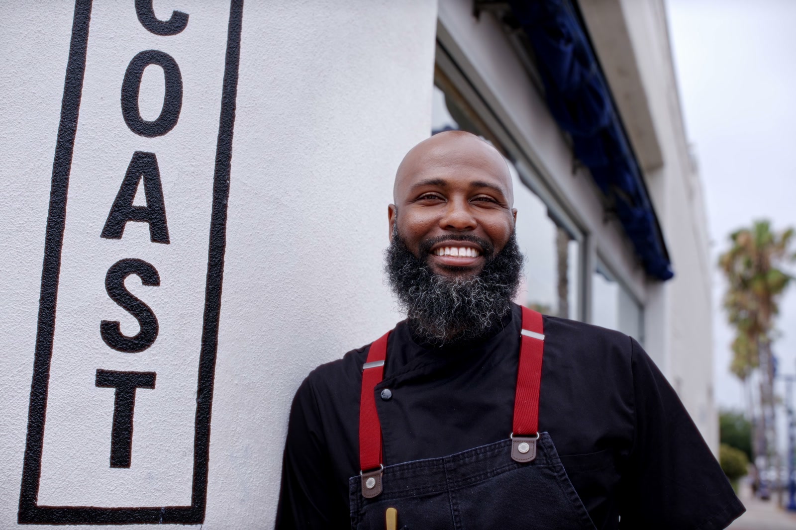 Kitchens for Good chef smiling outside the restaurant