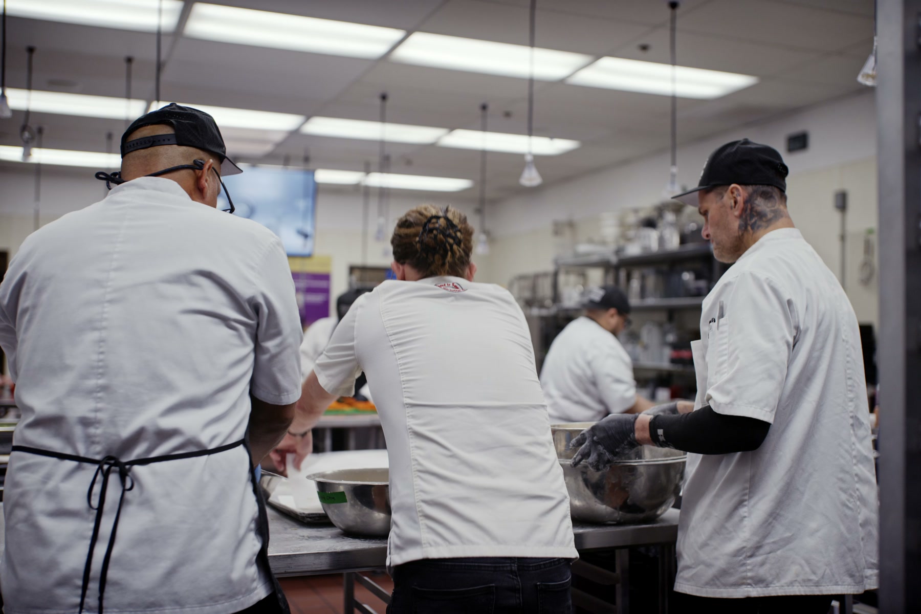 A Kitchens for Good team working together around a prep table